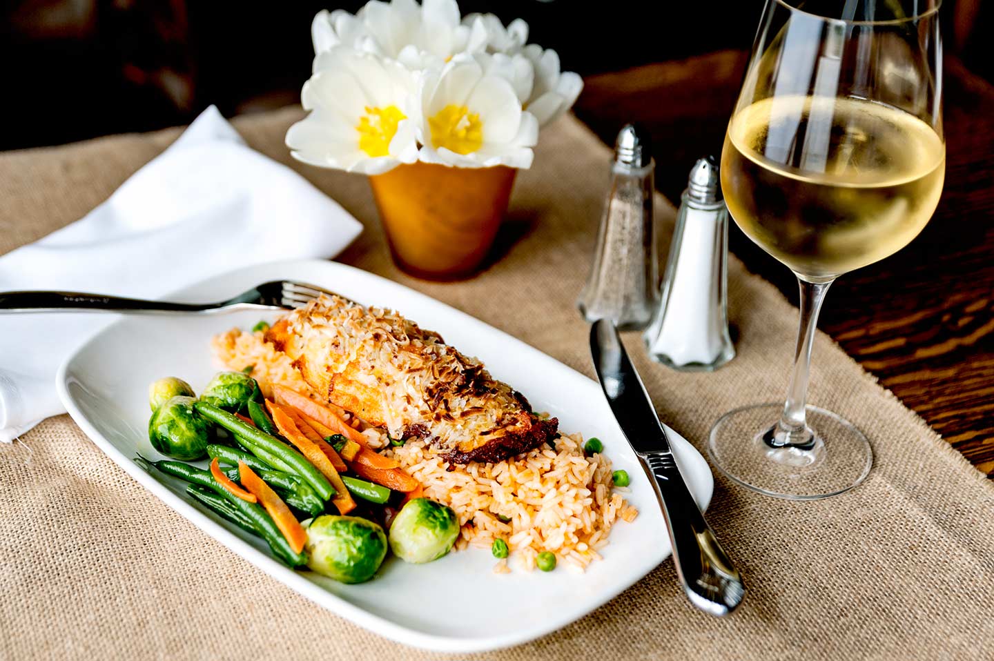 Coconut crusted salmon over seasonal veggies